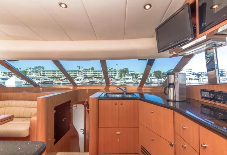  Yacht Photos Pics Luxurious interior of a 2005 Johnson 70 yacht with modern kitchen and marina view.