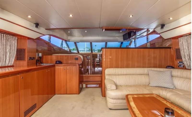  Yacht Photos Pics Luxurious interior of a 2005 Johnson 70 yacht with elegant wood finishes and plush seating.