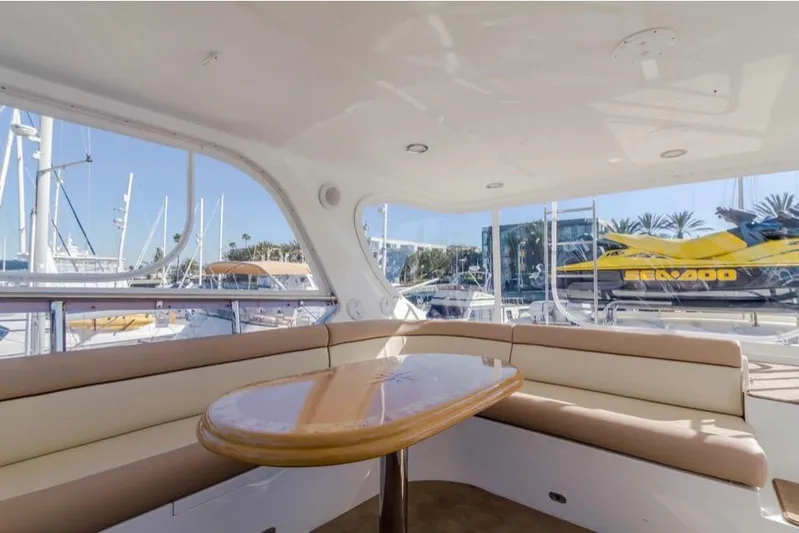  Yacht Photos Pics Luxurious 2005 Johnson 70 yacht interior with elegant seating and table, docked at marina.