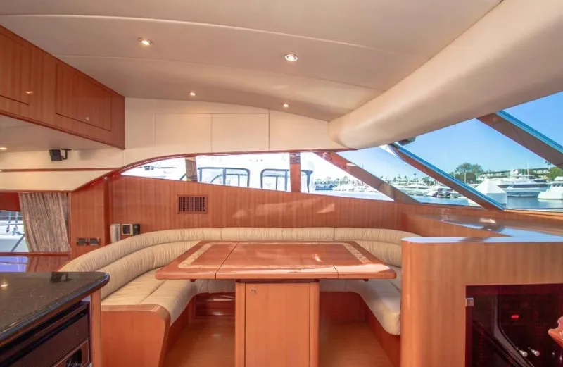  Yacht Photos Pics Luxurious interior of a 2005 Johnson 70 yacht with elegant wood finishes and spacious seating.