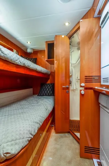  Yacht Photos Pics Interior of 2005 Johnson 70 yacht with cozy bunk beds and wooden finish.