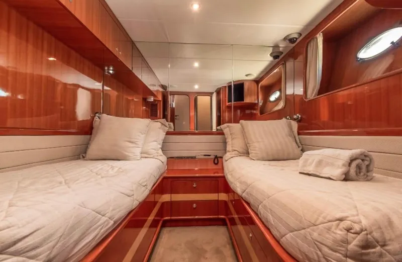  Yacht Photos Pics Luxurious cabin interior of 2005 Johnson 70 yacht with twin beds and wooden finish.