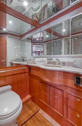 Yacht Photos Pics Luxurious yacht bathroom with wooden cabinetry and mirrored walls, Johnson 70, 2005 model.