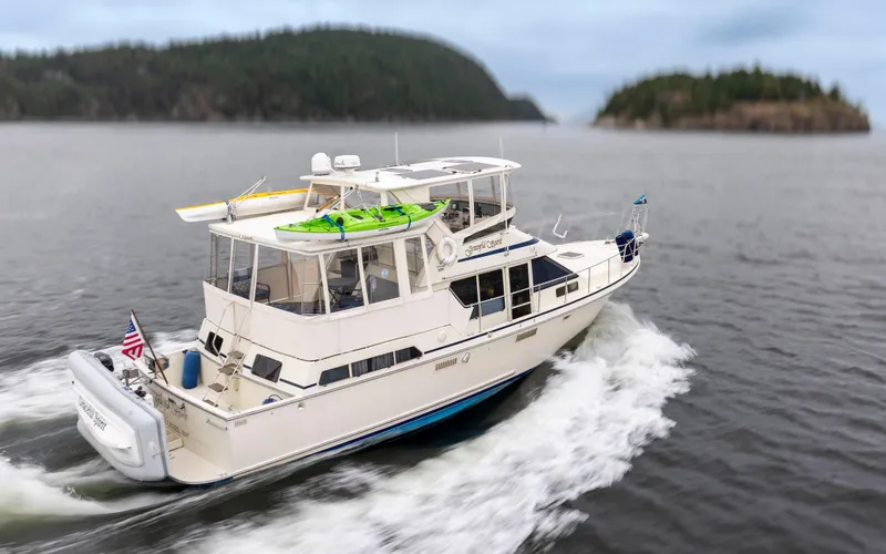 Graceful Spirit Yacht Photos Pics 1990 Tollycraft 44 Cockpit Motor Yacht cruising on open water with scenic island backdrop.