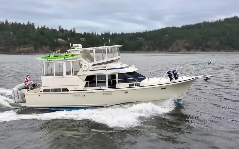 Graceful Spirit Yacht Photos Pics 1990 Tollycraft 44 Cockpit Motor Yacht cruising on a scenic waterway.