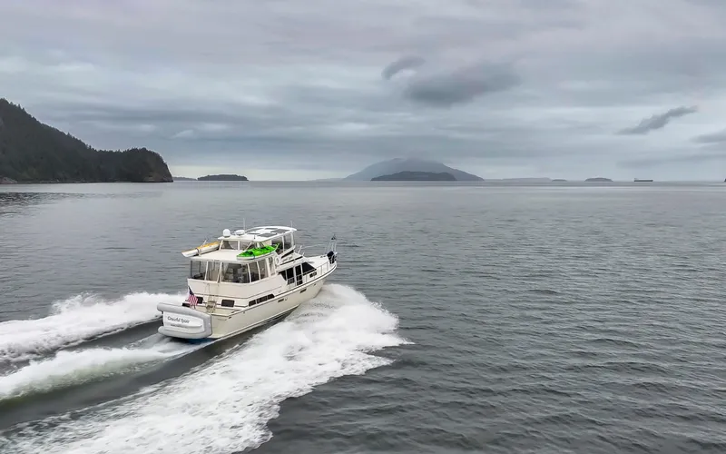 Graceful Spirit Yacht Photos Pics 1990 Tollycraft 44 Cockpit Motor Yacht cruising on open water under cloudy skies.