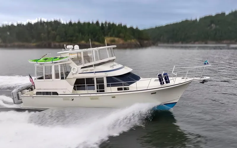 Graceful Spirit Yacht Photos Pics 1990 Tollycraft 44 Cockpit Motor Yacht cruising on a scenic waterway.