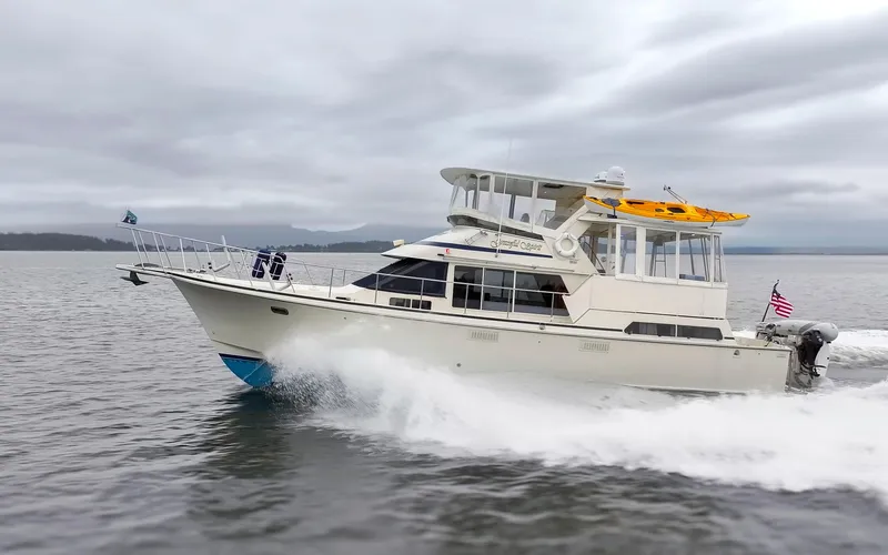 Graceful Spirit Yacht Photos Pics 1990 Tollycraft 44 Cockpit Motor Yacht cruising on open water under cloudy skies.