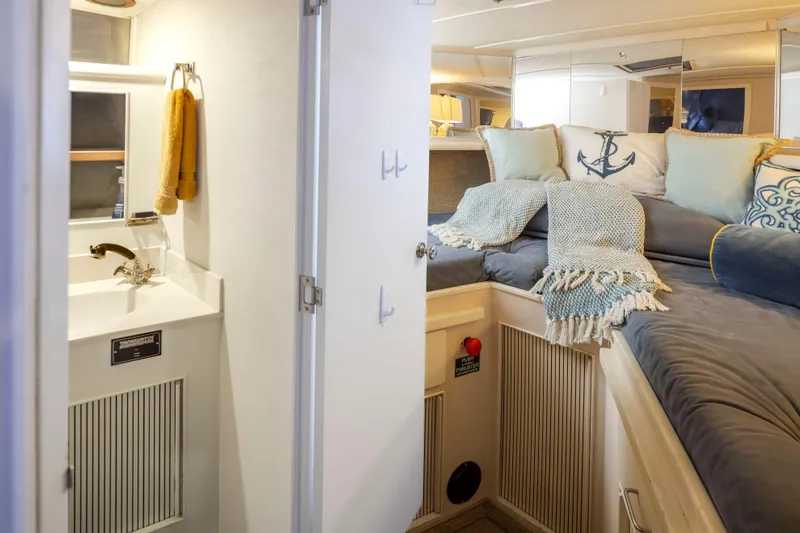 Graceful Spirit Yacht Photos Pics Interior of 1990 Tollycraft 44 Cockpit Motor Yacht with cozy bed and compact bathroom.