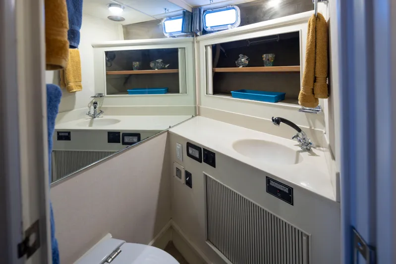 Graceful Spirit Yacht Photos Pics Bathroom interior of 1990 Tollycraft 44 Cockpit Motor Yacht with sink and mirror.