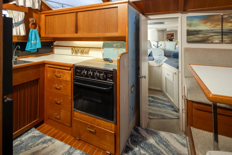 Graceful Spirit Yacht Photos Pics 1990 Tollycraft 44 Cockpit Motor Yacht interior with kitchen and cozy cabin.