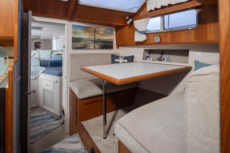 Graceful Spirit Yacht Photos Pics Interior of 1990 Tollycraft 44 Cockpit Motor Yacht with cozy dining area and nautical decor.
