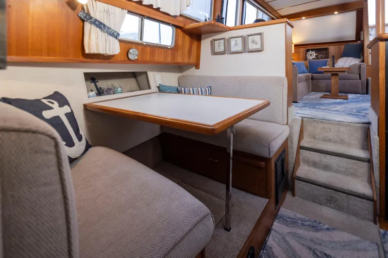 Graceful Spirit Yacht Photos Pics Interior of 1990 Tollycraft 44 Cockpit Motor Yacht with cozy dining area and nautical decor.