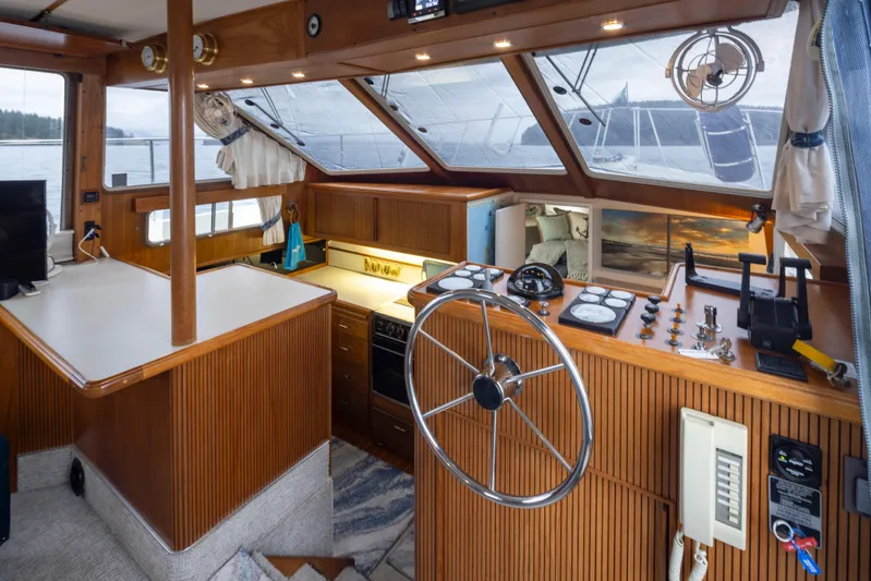 Graceful Spirit Yacht Photos Pics 1990 Tollycraft 44 Cockpit Motor Yacht interior with helm, wood paneling, and large windows.