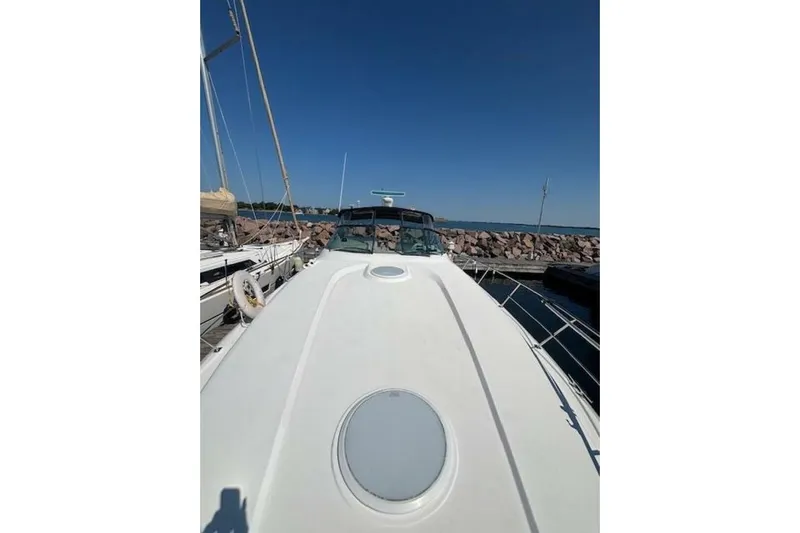  Yacht Photos Pics 2001 Cruisers Yachts 3870 docked, showcasing sleek deck design under clear blue sky.