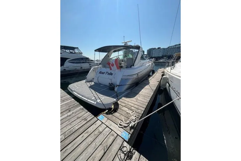  Yacht Photos Pics 2001 Cruisers Yachts 3870 docked at marina, rear view with Canadian flag.