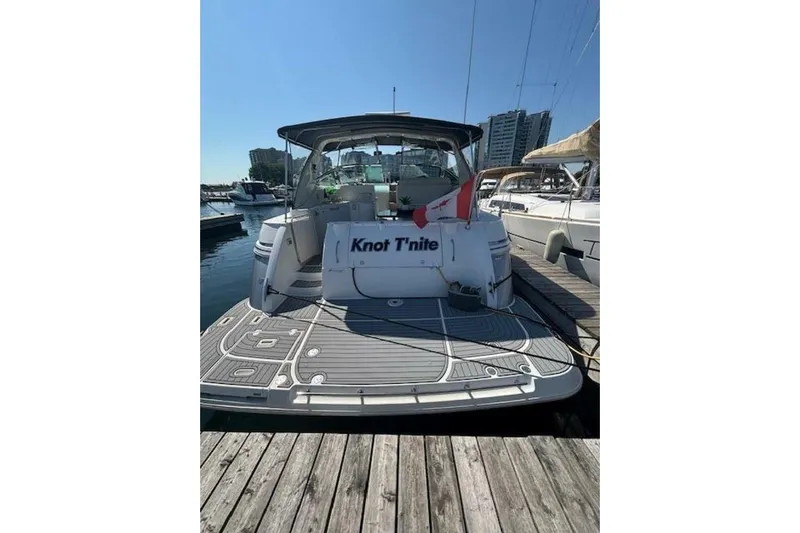  Yacht Photos Pics 2001 Cruisers Yachts 3870 docked, rear view with "Knot T'nite" name visible.
