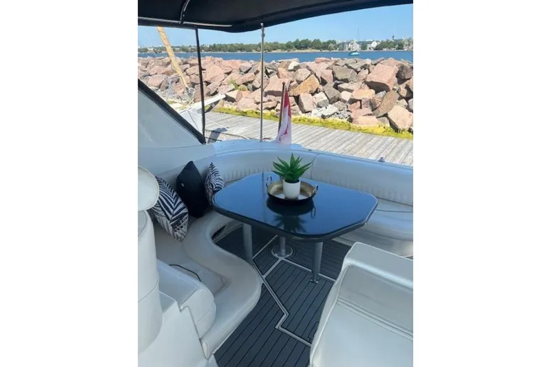  Yacht Photos Pics 2001 Cruisers Yachts 3870 interior with table, seating, and decorative plant, dockside view.