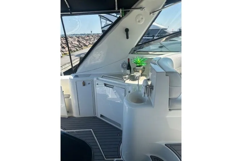  Yacht Photos Pics 2001 Cruisers Yachts 3870 interior with seating, sink, and decorative plant.