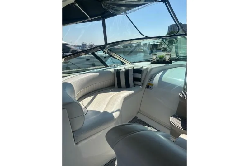  Yacht Photos Pics Luxurious interior of 2001 Cruisers Yachts 3870 with plush seating and striped cushions.