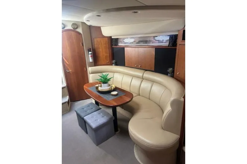  Yacht Photos Pics 2001 Cruisers Yachts 3870 interior with curved seating, wooden table, and modern decor.