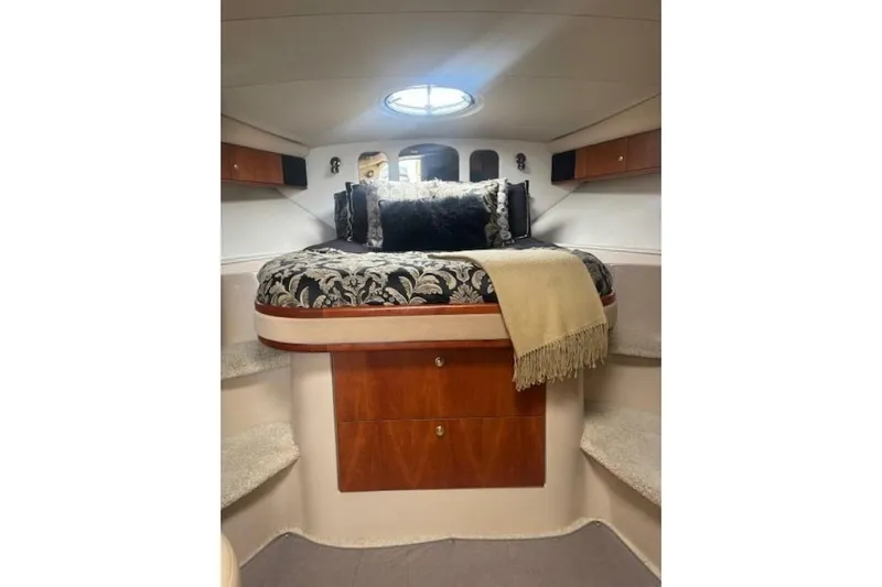  Yacht Photos Pics Luxurious cabin interior of 2001 Cruisers Yachts 3870 with elegant bedding and wood accents.