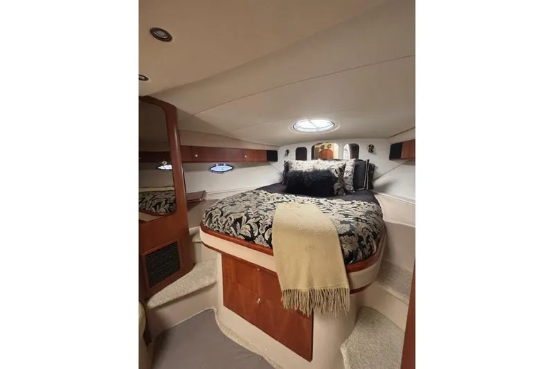  Yacht Photos Pics Luxurious cabin interior of 2001 Cruisers Yachts 3870 with elegant bedding and ambient lighting.