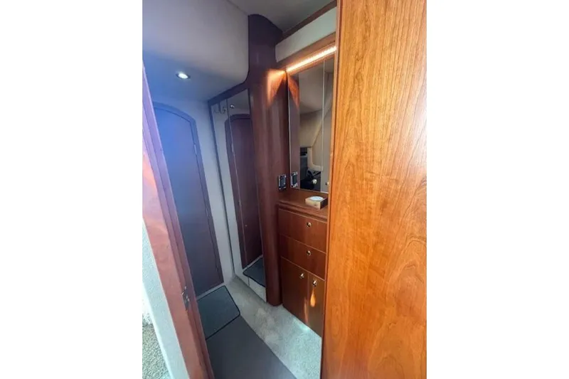  Yacht Photos Pics Interior of 2001 Cruisers Yachts 3870 with wooden cabinetry and mirror.