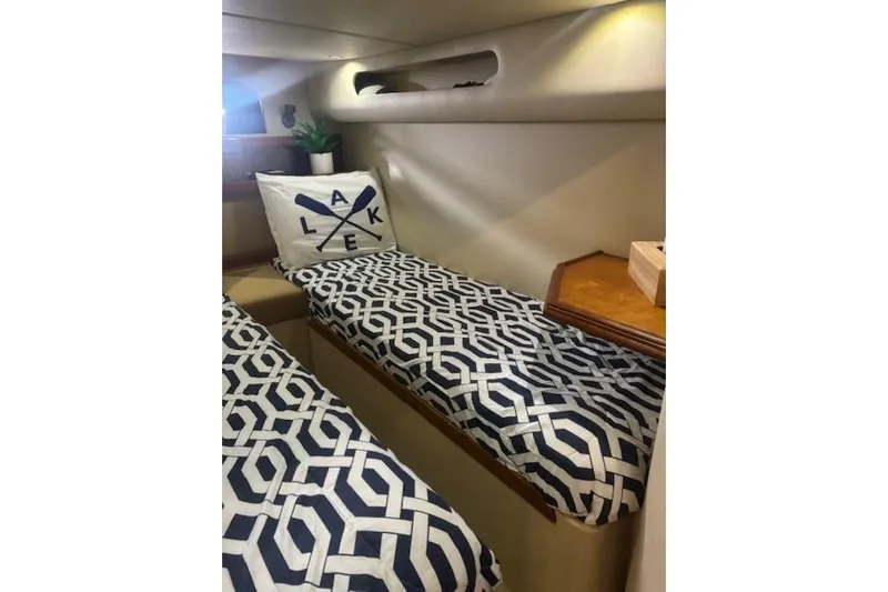  Yacht Photos Pics Interior of 2001 Cruisers Yachts 3870 with geometric-patterned bedding and decorative pillow.