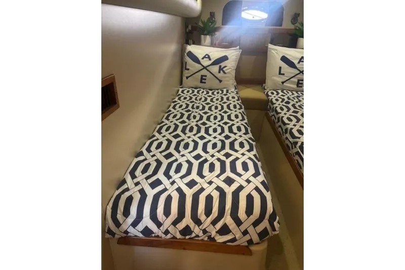  Yacht Photos Pics Interior of 2001 Cruisers Yachts 3870 with geometric-patterned bedding and decorative pillows.