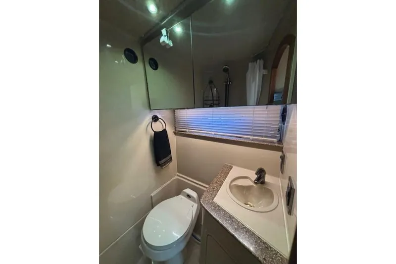  Yacht Photos Pics Bathroom interior of 2001 Cruisers Yachts 3870 with sink and toilet.