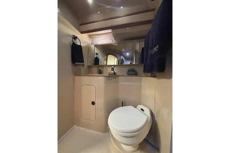  Yacht Photos Pics Bathroom interior of 2001 Cruisers Yachts 3870, featuring toilet and vanity.