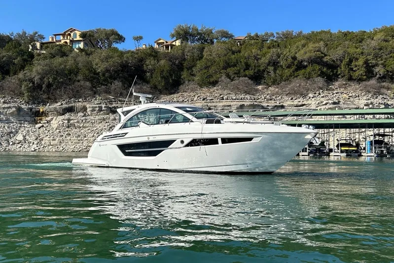 2021 Cruisers Yachts 50 Cantius Yacht Photos Pics 2021 Cruisers Yachts 50 Cantius on serene water with scenic backdrop.