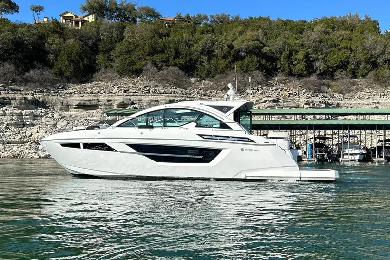 2021 Cruisers Yachts 50 Cantius Yacht Photos Pics 2021 Cruisers Yachts 50 Cantius on serene water near rocky shoreline.