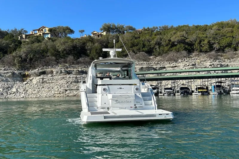 2021 Cruisers Yachts 50 Cantius Yacht Photos Pics 2021 Cruisers Yachts 50 Cantius on scenic lake with rocky shoreline backdrop.