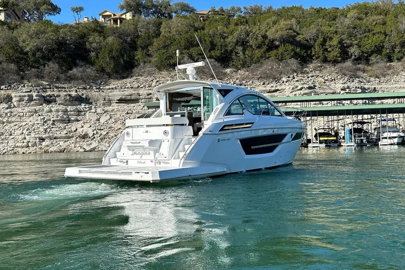 2021 Cruisers Yachts 50 Cantius Yacht Photos Pics 2021 Cruisers Yachts 50 Cantius on a scenic lake with rocky shoreline.