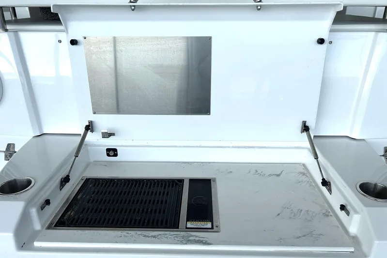 2021 Cruisers Yachts 50 Cantius Yacht Photos Pics Outdoor grill station on 2021 Cruisers Yachts 50 Cantius, featuring stainless steel and cup holders.