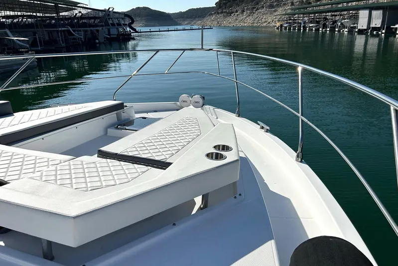 2021 Cruisers Yachts 50 Cantius Yacht Photos Pics 2021 Cruisers Yachts 50 Cantius bow with luxurious seating on calm water.