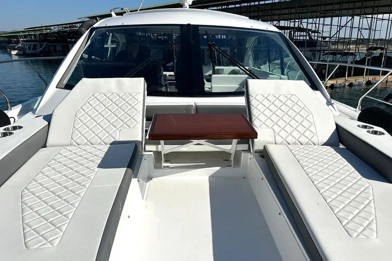2021 Cruisers Yachts 50 Cantius Yacht Photos Pics 2021 Cruisers Yachts 50 Cantius with luxurious white seating and wooden table on deck.
