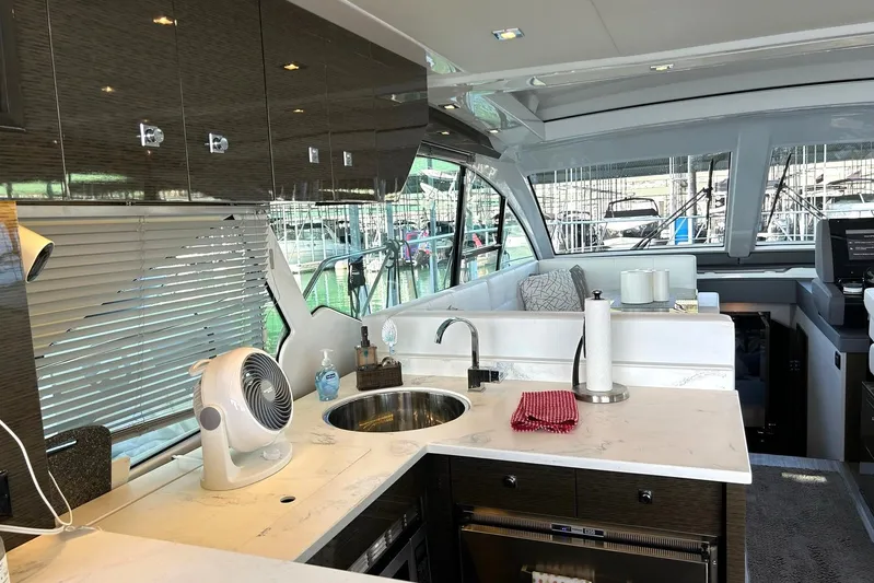 2021 Cruisers Yachts 50 Cantius Yacht Photos Pics Luxurious interior of 2021 Cruisers Yachts 50 Cantius with modern kitchen and seating area.