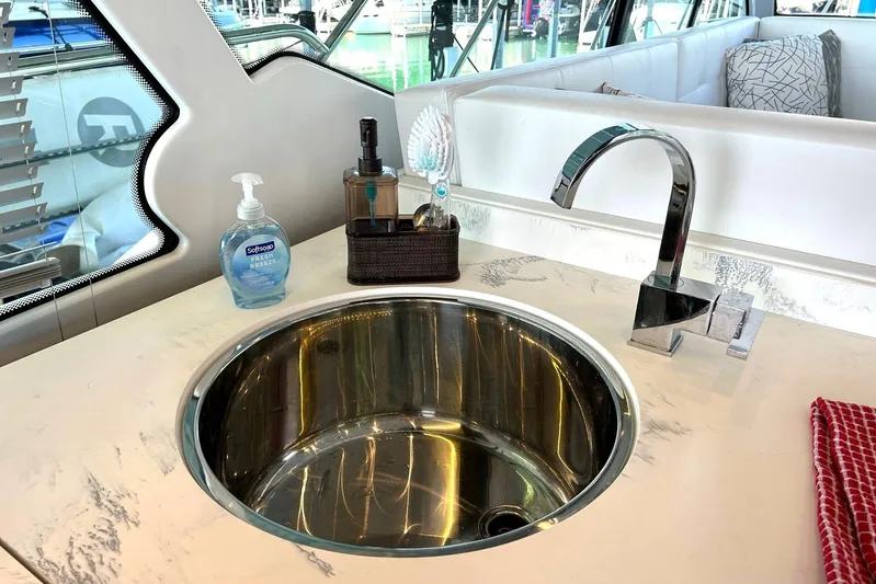 2021 Cruisers Yachts 50 Cantius Yacht Photos Pics Modern yacht kitchen sink with faucet, soap, and towel on 2021 Cruisers Yachts 50 Cantius.