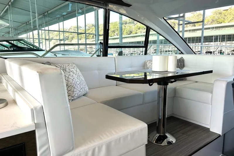 2021 Cruisers Yachts 50 Cantius Yacht Photos Pics Luxurious interior of 2021 Cruisers Yachts 50 Cantius with elegant white seating and modern table.