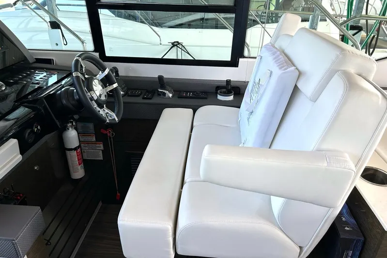 2021 Cruisers Yachts 50 Cantius Yacht Photos Pics 2021 Cruisers Yachts 50 Cantius helm with white seating and modern controls.
