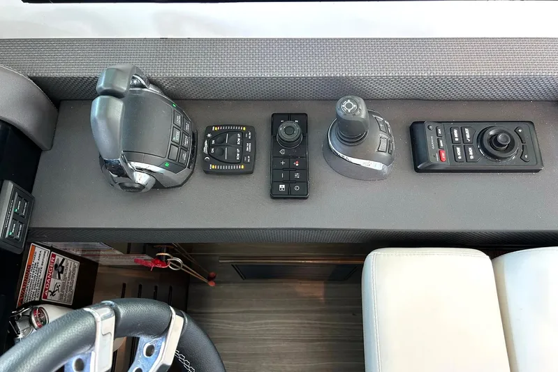 2021 Cruisers Yachts 50 Cantius Yacht Photos Pics Control panel of 2021 Cruisers Yachts 50 Cantius with joystick and throttle controls.