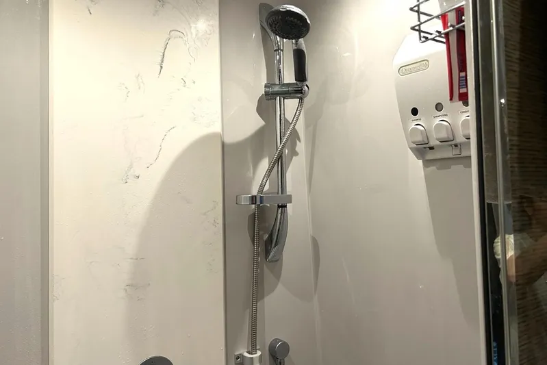 2021 Cruisers Yachts 50 Cantius Yacht Photos Pics Shower area in 2021 Cruisers Yachts 50 Cantius with dispenser and handheld showerhead.