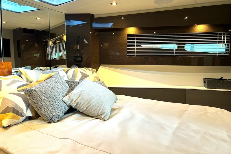 2021 Cruisers Yachts 50 Cantius Yacht Photos Pics Luxurious bedroom interior of 2021 Cruisers Yachts 50 Cantius with modern decor and pillows.