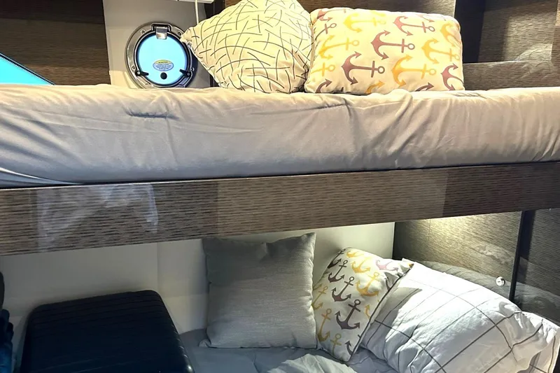 2021 Cruisers Yachts 50 Cantius Yacht Photos Pics Bunk beds in 2021 Cruisers Yachts 50 Cantius, featuring anchor-themed pillows.