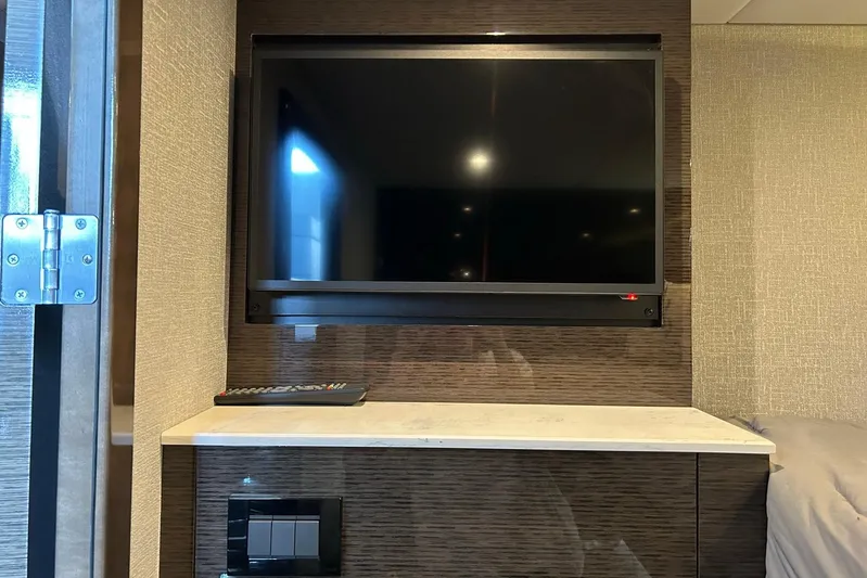 2021 Cruisers Yachts 50 Cantius Yacht Photos Pics Interior of 2021 Cruisers Yachts 50 Cantius with mounted TV and remote control.