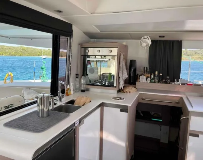 Elba 45 Yacht Photos Pics Modern kitchen interior of 2021 Fountaine Pajot Catamaran Elba 45 with ocean view.