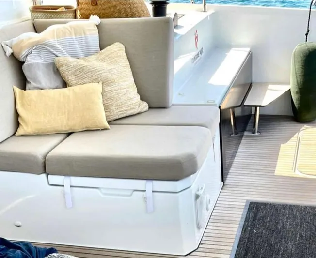 Elba 45 Yacht Photos Pics Cozy seating area on 2021 Fountaine Pajot Catamaran Elba 45 with cushions and pillows.